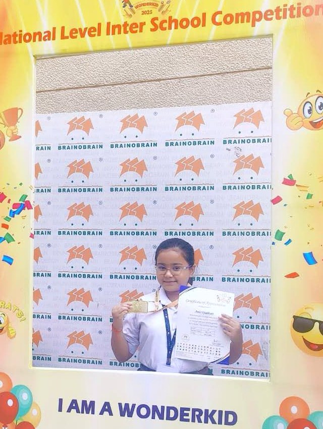 Student at the BOB Wonderkid national event with her Gold Topper certificate and medal