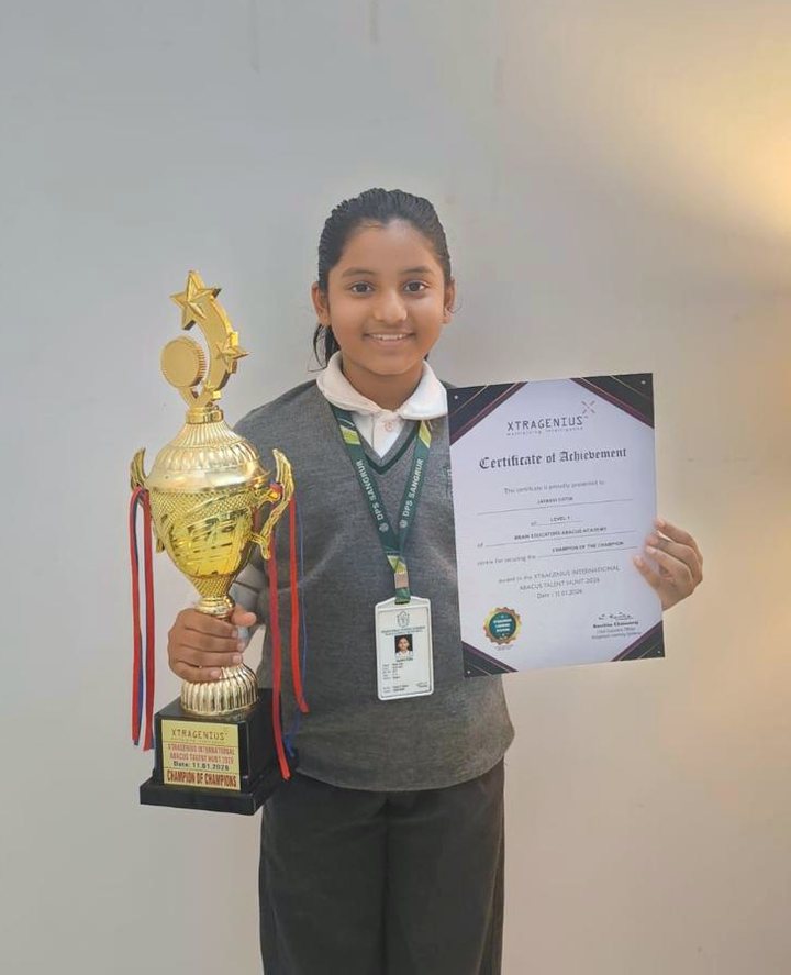 Student holding the Champion of Champions trophy and certificate