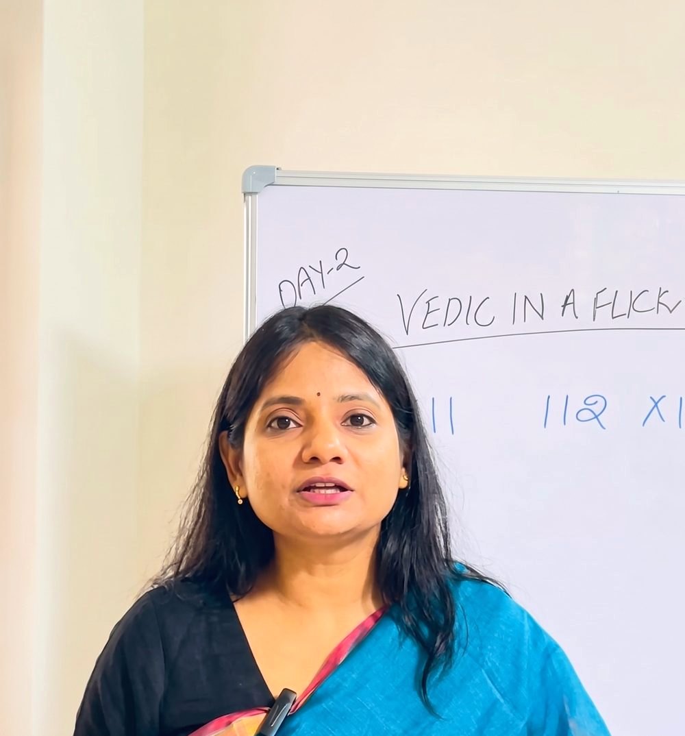 Yashu Cotia teaching Vedic maths at a whiteboard
