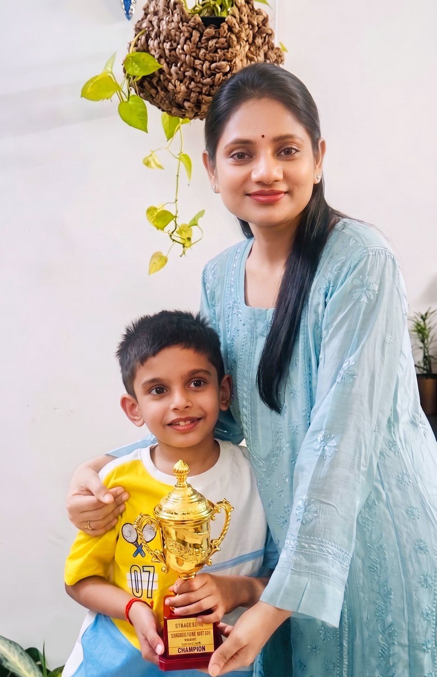 Yashu Cotia with a young champion and his trophy